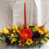 Festive centerpiece with candle and fall flowers for the center of the