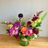 The combination of purple and orange flowers creates a harmonious and balanced