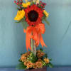 Autumn at the beach is a topiary style floral arrangement with bright