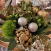 A subtle, textured, earth-toned arrangement perfect for any winter holiday. Consists of