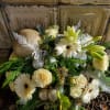 A lovely, neutral holiday arrangement of lilies, gerbera daisies, roses and spray