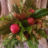 A lovely holiday display made of cedar, seeded eucalyptus, and real fruit.