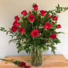 This elegant vase features a stunning arrangement of vibrant red roses, adding