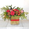 Reds and pinks in roses and protea in a joyful holiday collaboration.