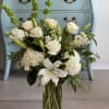 An elegant arrangement of white lilies, stunning hydrangea,  white roses and