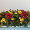24 inch centerpiece with reds and yellows. 

Blooms may vary. 