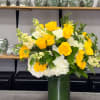 Features vibrant yellow roses paired with lush white hydrangea, creamy stock, and