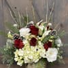 This beautiful seasonal design includes Winters greens, Roses, hydrangea, Lisianthus, Calla Lilys