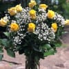 A beautiful dozen of long stem yellow roses arranged in a vase