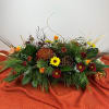 Fall blooms in a rustic wooden box with woodsy natural additions. Low