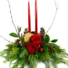 A traditional centerpiece is filled with fragrant pine, roses, pomegranate candles, cones