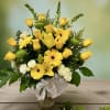 Bright and elegant arrangement designed with yellow roses, lilies, gerberas, and white