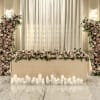 A luxurious pairing of floral columns and a full sweetheart-table arrangement, filled