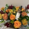  This exquisite arrangement features autumn-colored blooms elegantly displayed in a charming