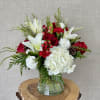 A delightful blend of vibrant red roses, snowy white casa blanca lilies