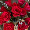 A Dozen Red Roses Arranged Low in a clear vase with Premium