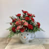 A Berry Cute snowman mug filled with fresh evergreens, red mini carnations