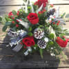 Winter bouquet with red and white flowers, berries and cones. Accented with