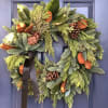 24&quot; round Wreath with a variety of Christmas greenery, magnolia leaves, berries