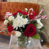 Celebrate with this fun and cheery holiday arrangement with Christmas greenery, red