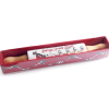 White ceramic rolling pin with wooden handles and a decal of Santa&#039;s