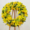 Sunny Remembrance Wreath is a luminous tribute featuring bright yellow roses and
