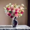 A delicate blend of soft pink roses, white lisianthus, alstroemeria, and rich