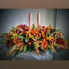 A  low centerpiece consisting of the freshest holiday themed flowers, with