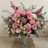 This elegant floral arrangement features a lush mix of pink and white