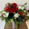 Lovely flower arrangement in a shiny cylinder vase with a variety of