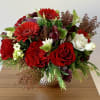A festive holiday flower arrangement in Supernova Pot by Accent Decor. A