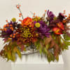 Fall inspired arrangement in 12 inch long vase with roses, mums and
