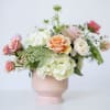 A charming collection of fluffy hydrangea, blushing roses, and delicate laceflower housed