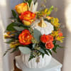 This beautiful floral arrangement features warm, vibrant tones perfect for the season.
