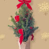 This wonderful tree is decorated with red ribbon, artificial berries, pinecones and