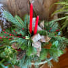 Long lasting evergreen tablespace with 2 candles, pine cones, holly and ribbon.