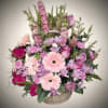 Bright, elegant, and full of charm, this Pink Garden Basket features a