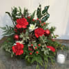A small Christmas greens arrangement with minimalistic red accents for adding a