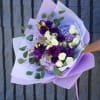 The Lavender Elegance Bouquet is a stunning arrangement featuring deep purple lisianthus