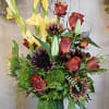 With a dozen roses, multi colored sunflowers, and nova lux gladiolus this