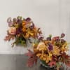 Mauve and orange fall arrangements. 

Two(2) small arrangements to place on a