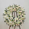 Honor a cherished memory with this elegant memorial wreath. Pristine white roses