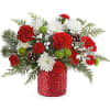 Teleflora&#039;s Christmas Magic Bouquet sparkles with red and green blooms, festive evergreens
