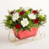 Send holiday joy their way! Our dashing arrangement features classic Christmas-colored blooms