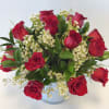 Low and Lush 18 Roses with complimenting white wax and greenery.

Please Specify