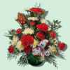 A festive metal tin is filled with holiday red and white carnations