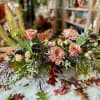 lush fall florals with texture elements and greens in a low wooden