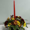 This autumn piece features one candle and a variety of mums, carnations