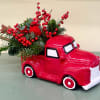10/5.5 inch red truck vase with holiday greens.