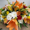 This lush centerpiece features all the fall tones set off by bright